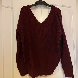 Never worn burgundy sweater, with twist so can be worn in the front or back